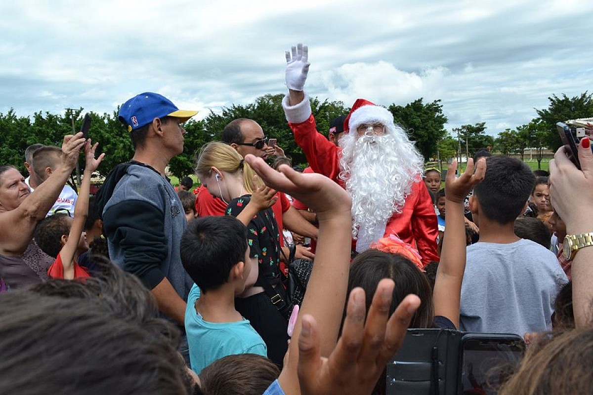 Papai Noel é recepcionado por crianças após descer de paraquedas na Emapa